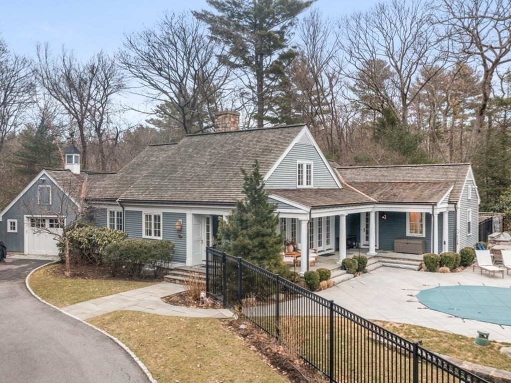 a front view of a house with yard and trees in it