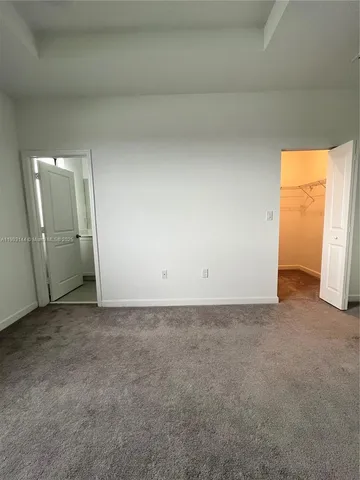 a view of an empty room and a window