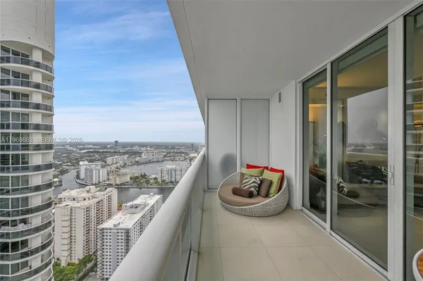 a view of a balcony and dining area with a balcony