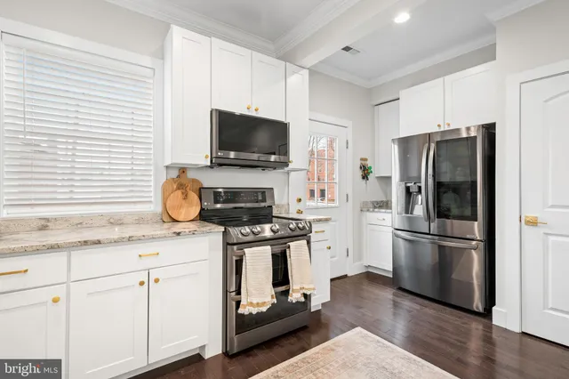 a kitchen with appliances a sink and a window