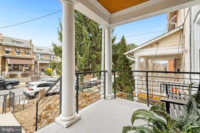 a balcony with furniture and a potted plant