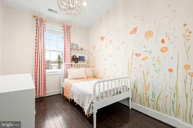 a bed sitting in a bedroom next to a window