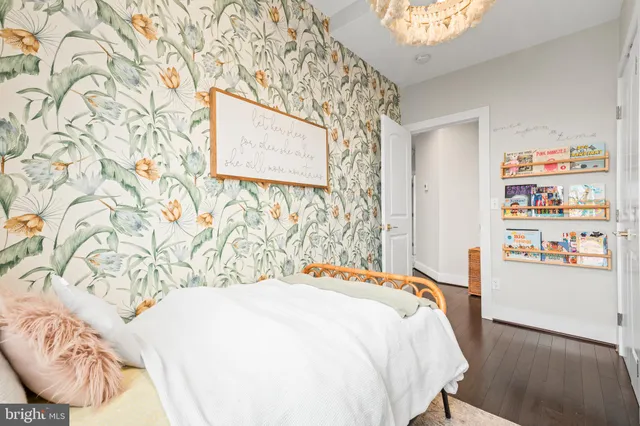 a bedroom with a bed and a wooden floor