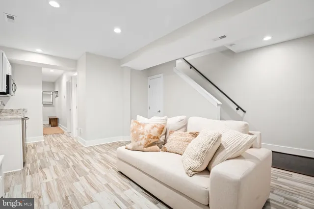 a living room with furniture and wooden floor
