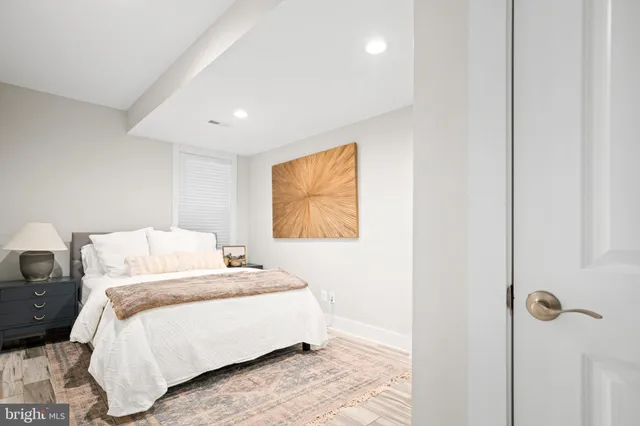 a bedroom with a bed and wall painting