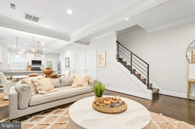 a living room with furniture and a dining table