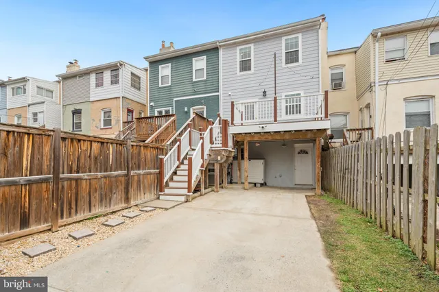 a view of a house with wooden fence