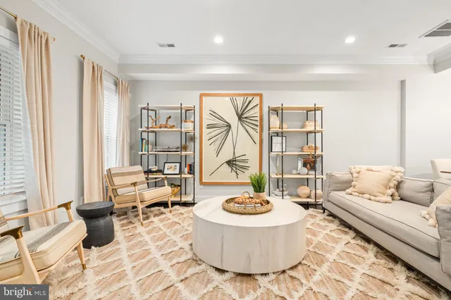 a living room with furniture and a floor to ceiling window