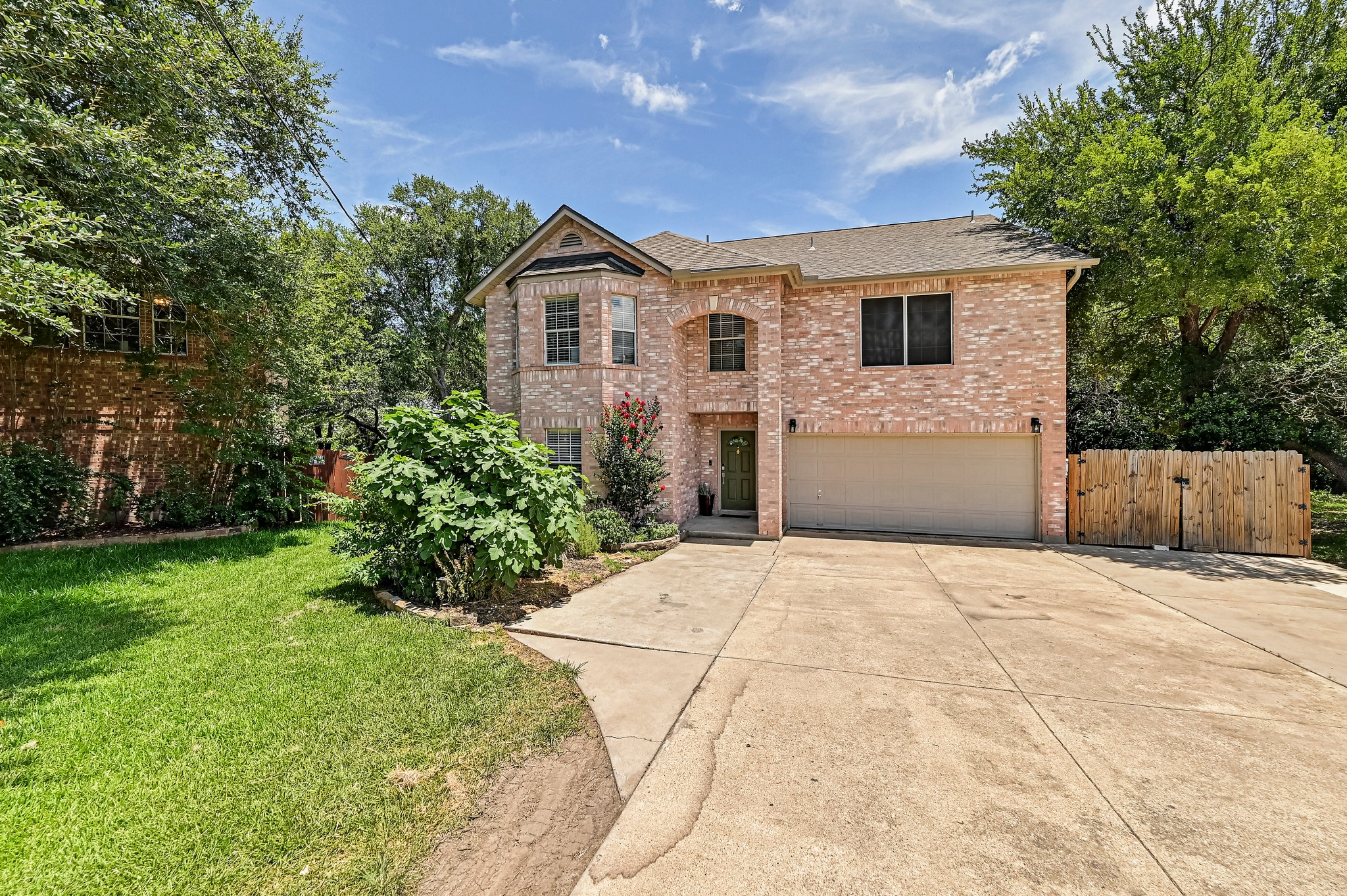 104 North Sumac Lane Georgetown, TX 78633 - Photo 4 of 40 This classic brick residence presents a welcoming facade with a convenient driveway leading to an integrated garage.