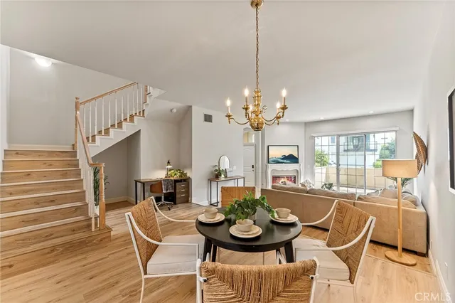 a view of a dining room with furniture wooden floor and chandelier