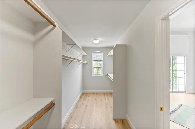 a view of a hallway with wooden floor and entryway
