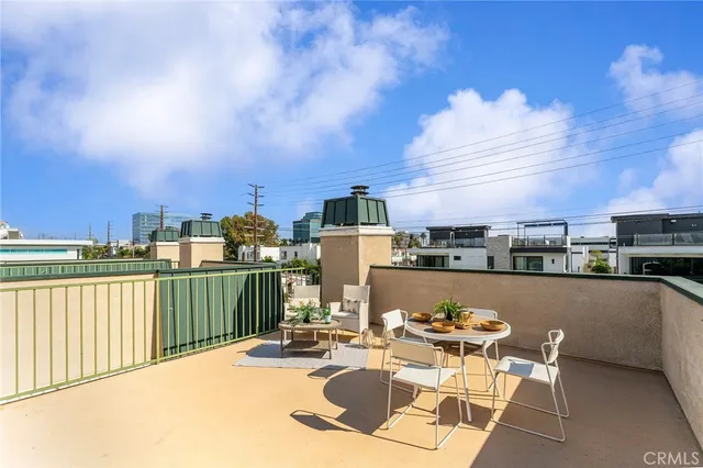 a terrace with outdoor seating and city view