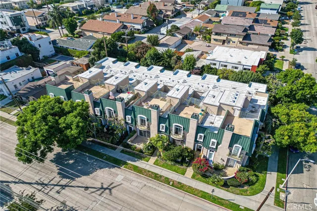 an aerial view of multiple houses with yard