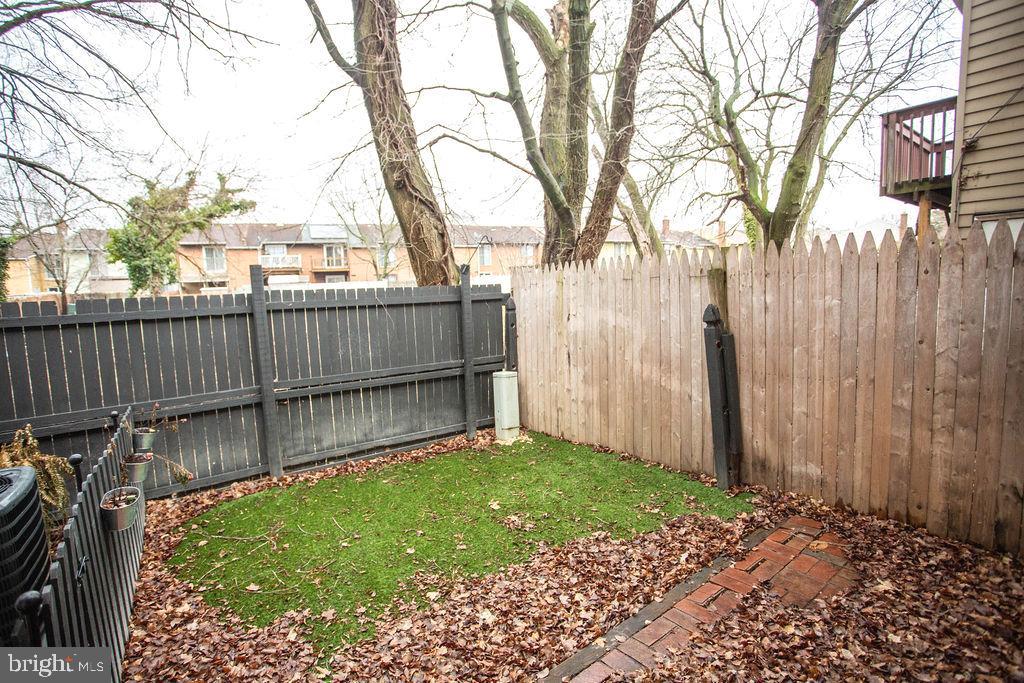 35 Via Cascata Drive Clementon, NJ 08021 - Photo 40 of 43 a view of a backyard with a large tree and wooden fence