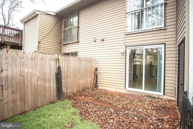 a view of a house with a backyard and wooden door