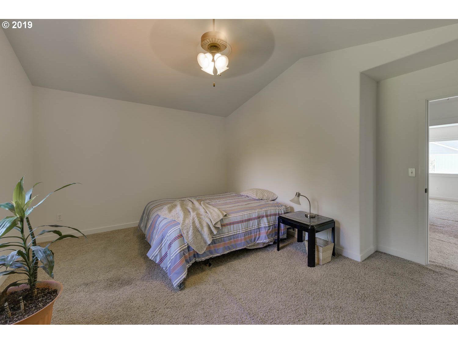 39573 Dubarko Road Sandy, OR 97055 - Photo 12 of 18 a bedroom with a bed and a chandelier