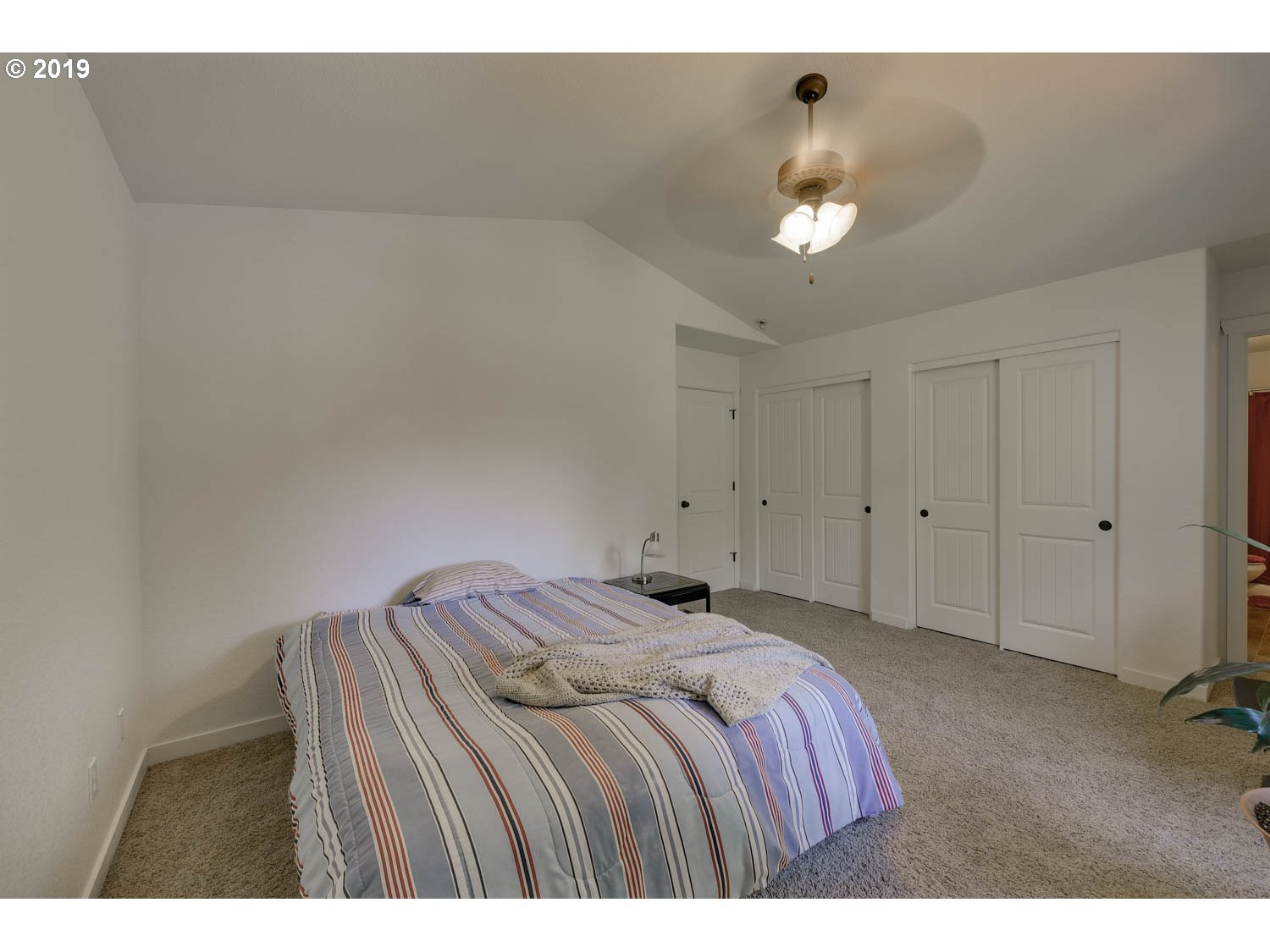 39573 Dubarko Road Sandy, OR 97055 - Photo 13 of 18 a bedroom with a bed and a chandelier