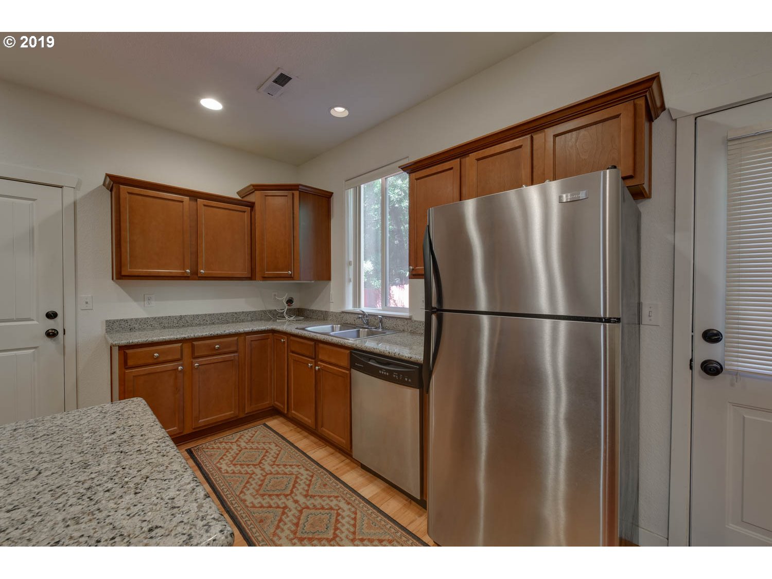 39573 Dubarko Road Sandy, OR 97055 - Photo 9 of 18 a kitchen with granite countertop stainless steel appliances a refrigerator and cabinets