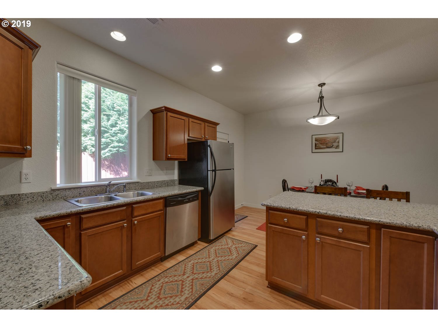 39573 Dubarko Road Sandy, OR 97055 - Photo 10 of 18 a kitchen with granite countertop a sink stainless steel appliances and cabinets