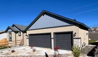 a view of wooden house and a yard