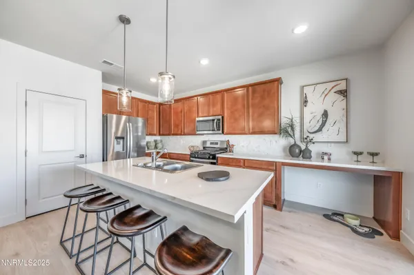 a kitchen with a sink a refrigerator and cabinets