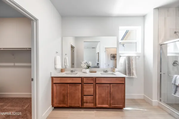 a bathroom with a double vanity sink mirror double and shower