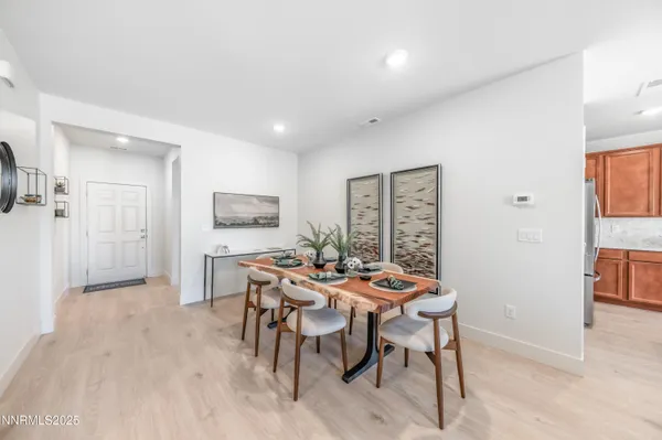 a living room with furniture a fireplace and kitchen view