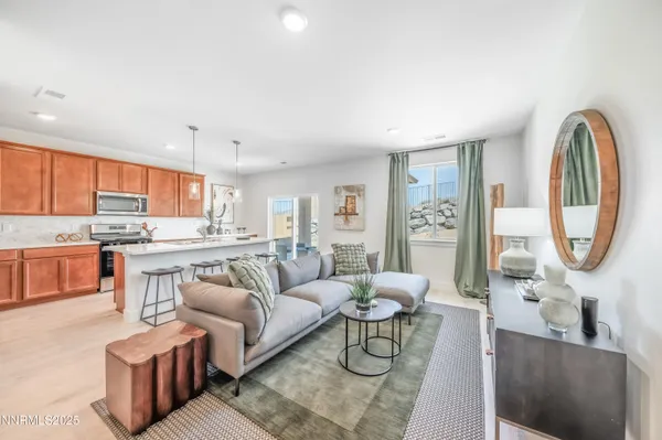 a living room with furniture a clock on wall and a window