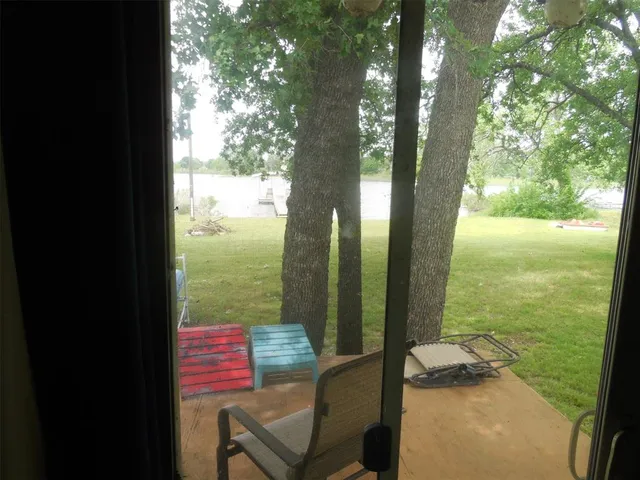 a bedroom with a bed table and window