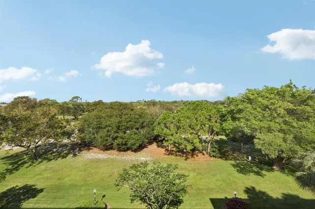 a dining room with furniture a chandelier and window