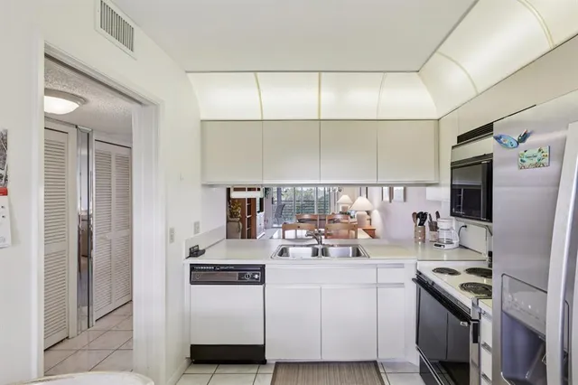 a kitchen with stainless steel appliances a stove a refrigerator and a sink