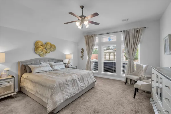 a bedroom with a bed and a large window