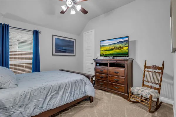 a bedroom with a bed and a television