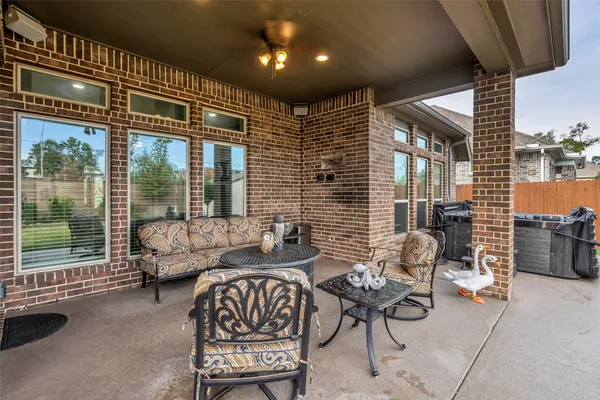 a balcony with furniture and a potted plant
