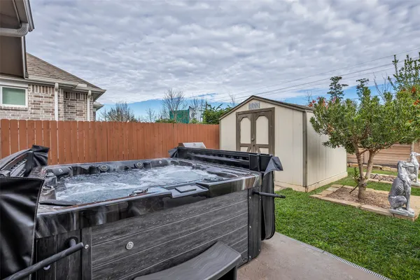 a view of a house with a tub and a yard