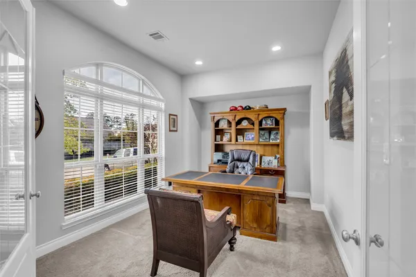 a dining room with furniture and a window