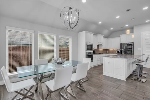 a view of kitchen with dining table and chairs