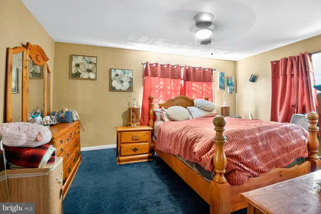 a bedroom with a bed couch and a window