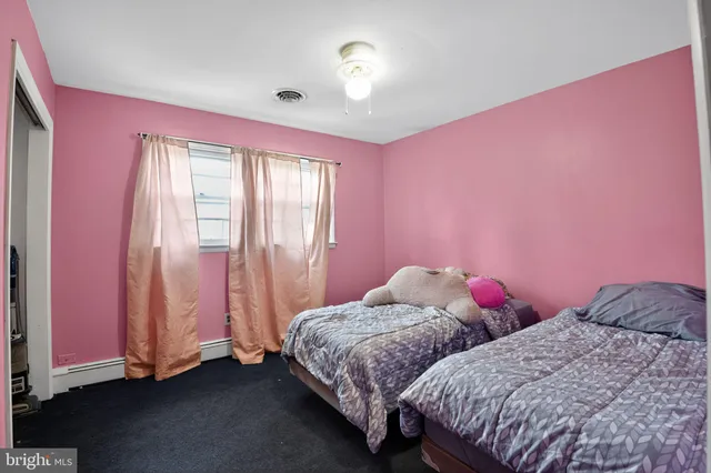 a view of a yard with wooden fence