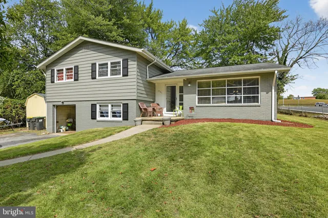 a front view of a house with a yard and porch