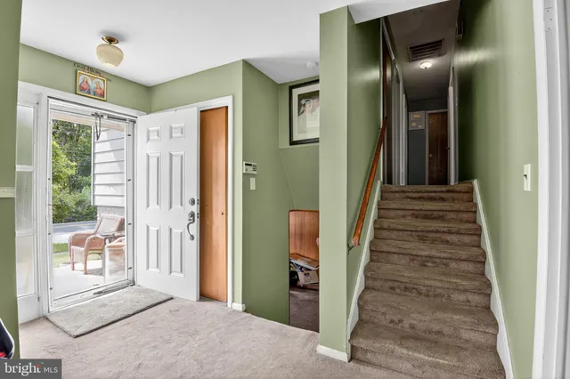 a view of a hallway with wooden floor and windows