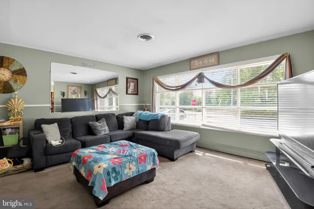 a view of a dining room with furniture and a chandelier