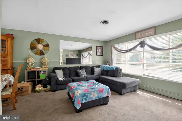 a view of a dining room with furniture and a chandelier