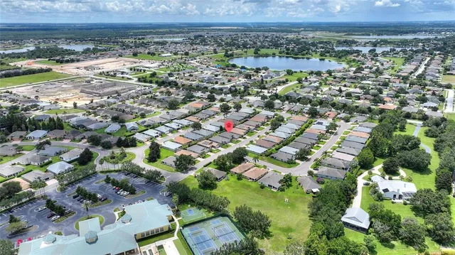an aerial view of a house with a yard