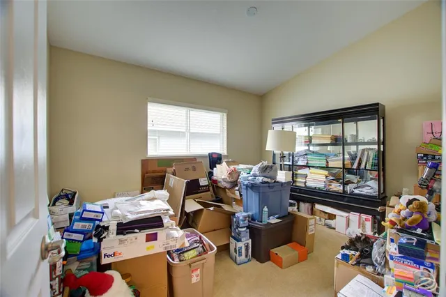 a bedroom with a bed gym equipment and a chandelier