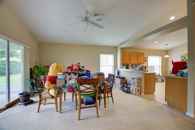 a view of a dining room with furniture and a potted plant