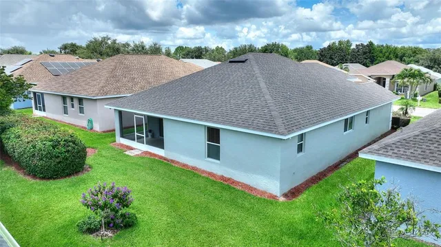 a aerial view of a house with a yard and potted plants