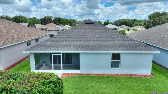 a aerial view of a house with a yard and potted plants