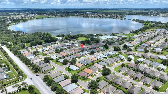 an aerial view of a house with a yard