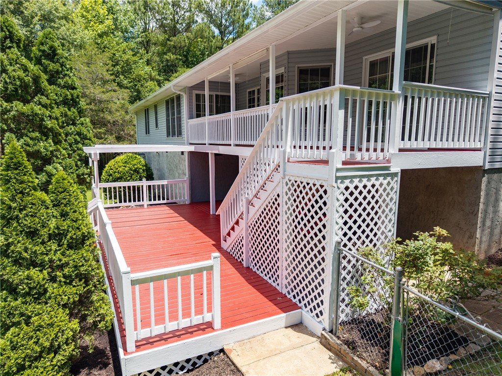 429 Burns Mill Road West Union, SC 29696 - Photo 3 of 49 An inviting multi-level deck extends from this light-toned residence, enveloped by verdant trees.